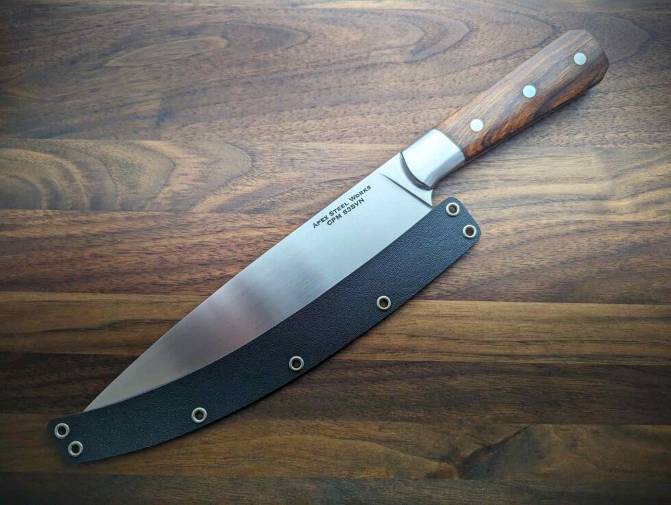 Apex Steel Works 8 inch S35VN Chef's Knife desert ironwood #002 002 showing logo side of S35VN blade, desert ironwood handle, and kydex blade guard.